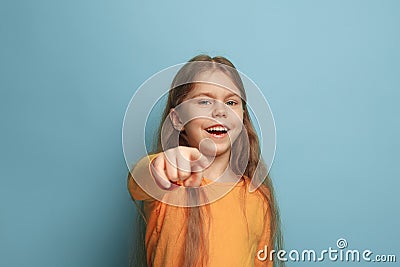 The determination. Teen girl on a blue background. Facial expressions and people emotions concept Stock Photo