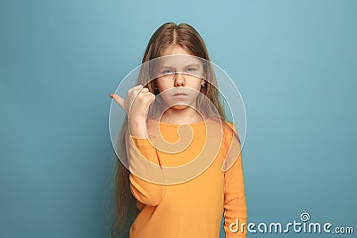 The determination. Teen girl on a blue background. Facial expressions and people emotions concept Stock Photo