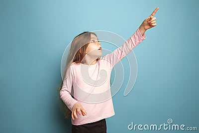 The determination. Teen girl on a blue background. Facial expressions and people emotions concept Stock Photo