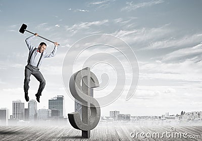 Determined banker man against modern cityscape breaking dollar concrete figure Stock Photo