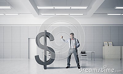 Determined banker man in modern office interior breaking dollar figure Stock Photo