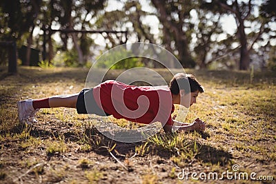 Determined kid exercising during obstacle course Stock Photo