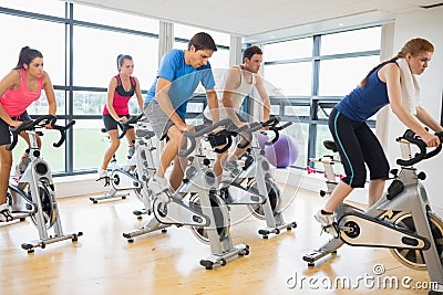 Determined people working out at spinning class Stock Photo