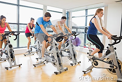 Determined people working out at spinning class Stock Photo
