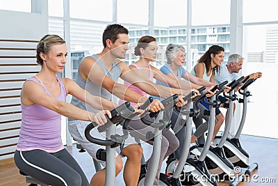 Determined people working out at spinning class Stock Photo