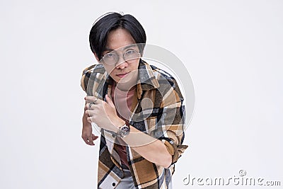 A determined young chinese man running forward in an exaggerated way. Active dynamic teenager in motion. Isolated on a white Stock Photo
