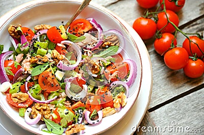 Detox food with veggie, raw salad with tomato and walnuts Stock Photo