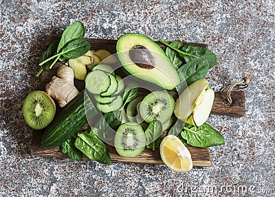 Detox green vegetables and fruits on a wooden board. Concept of a healthy, diet food. Stock Photo