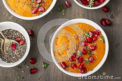 Detox and healthy breakfast smoothie of ripe juicy fruits persimmon, pomegranate seeds, chia with honey thyme on a Stock Photo