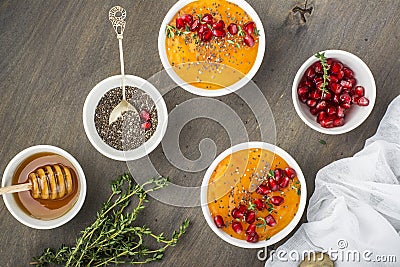 Detox and healthy breakfast smoothie of ripe juicy fruits persimmon, pomegranate seeds, chia with honey thyme on a Stock Photo