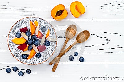 Detox and healthy superfoods breakfast bowl concept. Vegan coconut milk chia seeds pudding over rustic table with various fruits Stock Photo