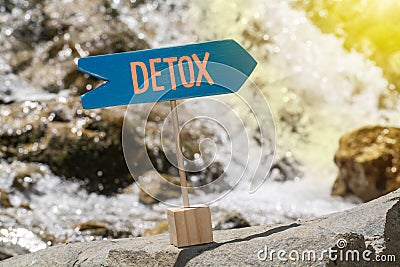 Detox sign board on rock Stock Photo