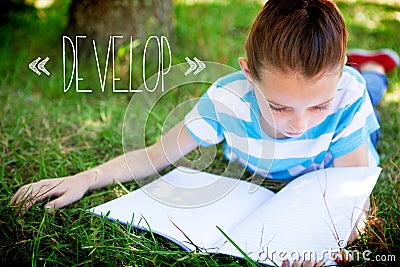 Develop against cute little girl reading in park Stock Photo