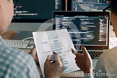 Developing programming and coding technologies working in a software engineers developing applications together in office Stock Photo