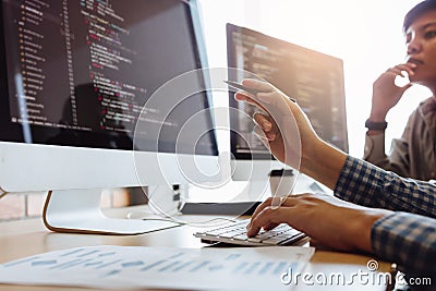 Developing programming and coding technologies working in a software engineers developing applications together in office Stock Photo