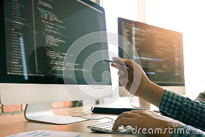 Developing programming working in a software engineers code tech applications on desk in office room Stock Photo