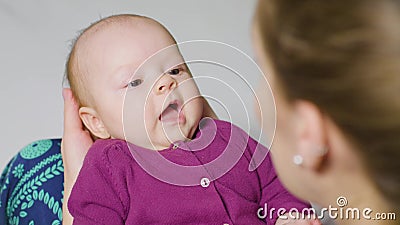 Mother with Baby on Her Knees Stock Photo