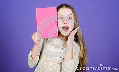 Development and education. Reading skill. Personal diary. Textbook presentation. Study and learn. Girl hold book violet Stock Photo