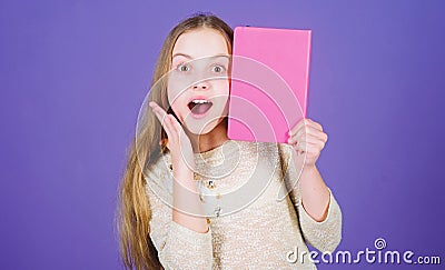 Development and education. Reading skill. Personal diary. Textbook presentation. Study and learn. Girl hold book violet Stock Photo