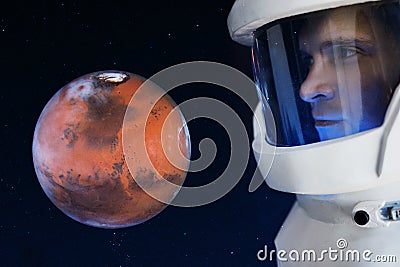 Development of Mars, concept. Astronaut, looking at the planet Mars. Elements of this image furnished by NASA. Stock Photo