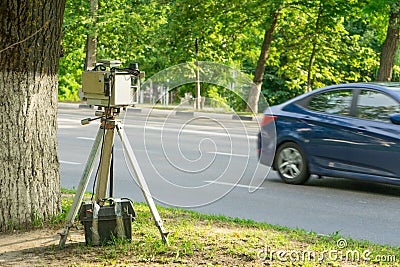 The device for measuring the speed of the car. The police hid behind a tree. Stock Photo