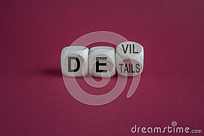 Devil in the details symbol. Turned cubes and changed the word details to devil. Beautiful red background. Business and devil in Stock Photo