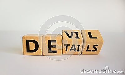 Devil in the details symbol. Turned cubes and changed the word `details` to `devil`. Beautiful white background. Business and Stock Photo