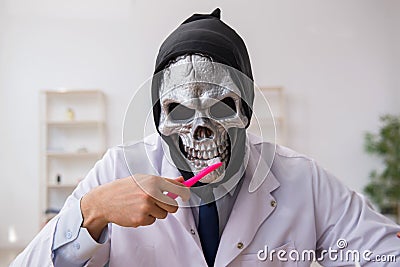 Devil doctor stomatologist working in the clinic Stock Photo