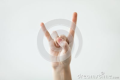 Devil horns gesture with fingers on the light background. Icon, sign Stock Photo