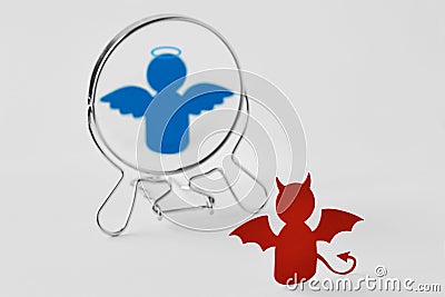 Devil looking in the mirror and seeing himself as an angel - Good and evil, distorted self-image concept Stock Photo