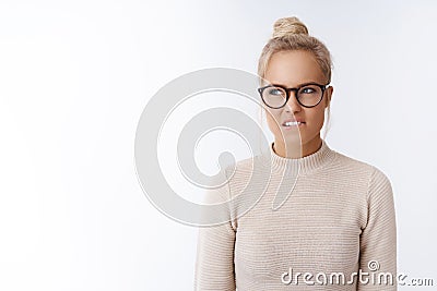 Devious angry woman holding anger inside swearing and cursing ashole in queue biting lip and grimacing frowning from Stock Photo