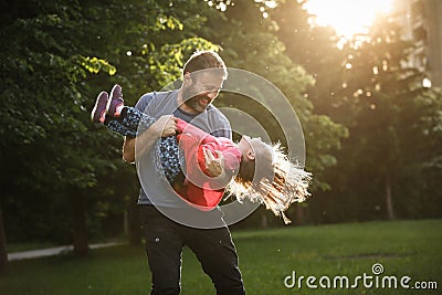 Devoted father spinning his daughter in circles Stock Photo