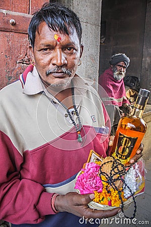 Devotee offering liquor Editorial Stock Photo