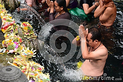 Devotees at the ritual purification in the temple pond. Tirta Empul. Tampaksiring. Gianyar regency. Bali. Indonesia Editorial Stock Photo