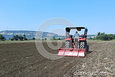 22-10-2021, Dewas, M.P. India. Plowing the field with a tractor, farmers preparing the field before sowing the crop, a new Editorial Stock Photo