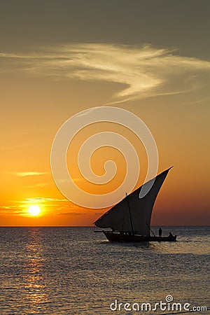 Dhow sailing during sunset in Zanzibar. Stock Photo