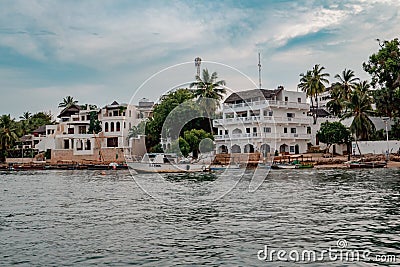 Dhows and boats moored at shore against buildings in Shela Beach, Lamu Island, Kenya Editorial Stock Photo