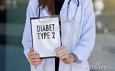 Diabet Type 2 text with stethoscope and pills on hands doctor Stock Photo