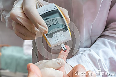 Diabetes concept. Doctor is monitoring blood glucose level. Stock Photo