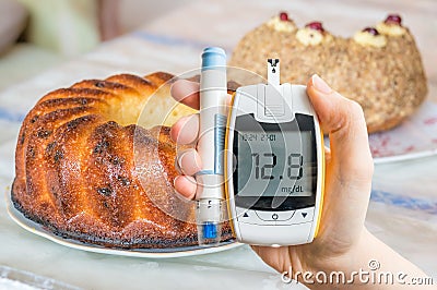 Diabetes, diet and unhealthy eating concept. Hand holds glucometer. Stock Photo