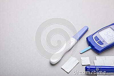 Diabetes mellitus, increased blood sugar in pregnant women. Glucometer and positive test for variability. Gray background Stock Photo