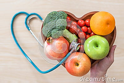 Diabetes monitor, Cholesterol diet and healthy food eating nutritional concept with clean fruits in nutritionist`s heart dish Editorial Stock Photo