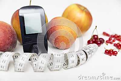 Diabetes monitor, diet and healthy food eating nutritional concept with clean fruits with diabetic measuring tool kit ans Stock Photo