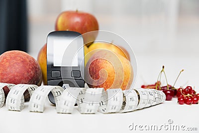 Diabetes monitor, diet and healthy food eating nutritional concept with clean fruits with diabetic measuring tool kit ans Stock Photo