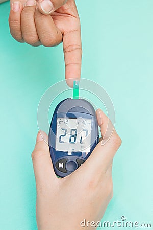 Diabetic patient measuring glucose Stock Photo