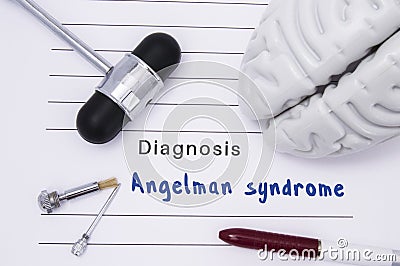 Diagnosis of Angelman syndrome. Neurological hammer and brain figure lie on a medical paper form with a heading diagnosis of Ange Stock Photo