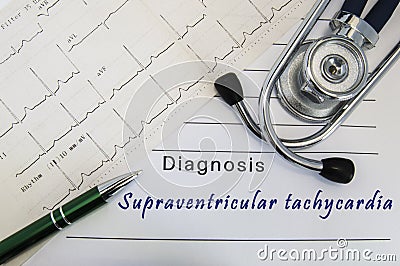 Diagnosis of Supraventricular tachycardia. Stethoscope, green pen and electrocardiogram lie on medical form with diagnosis of Supr Stock Photo