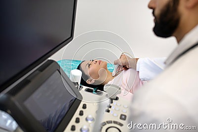 Asian woman laying on the couch having ultrasonic investigation Stock Photo