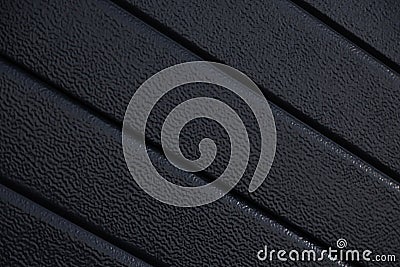 Diagonal close-up of black striped corrugated surface with uneven texture Stock Photo