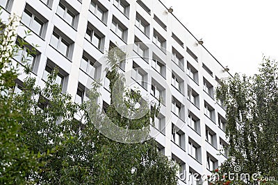 Diagonal view of education establishment building with trees before it. Stock Photo